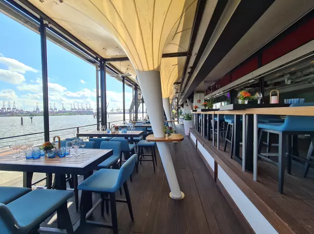 Terrasse des am kai Club mit Blick auf die Elbe – Gäste im Außenbereich