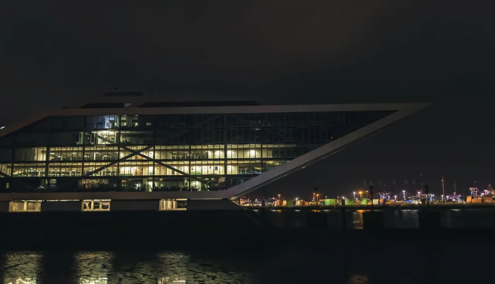 Dockland am Hamburger Hafen bei Nacht – Eventlocation am kai Hamburg mit beleuchteter Glasfassade